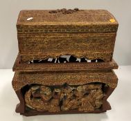 A Burmese carved and gilded wooden dome top miniature trunk on stand,
