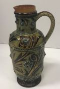 A Doulton Lambeth relief work and incised foliate decorated jug, dated 1875,