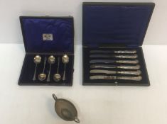 A cased set of six silver handled pistol grip butter knives with floral decoration (Sheffield,