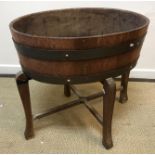 A mid 20th Century brass bound coopered oak oval jardiniere or wine cooler on cabriole leg base,