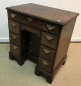 A George III mahogany kneehole desk of small proportions,