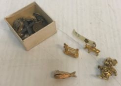 A collection of 9 carat gold charm bracelet charms comprising one in the form of a whale with