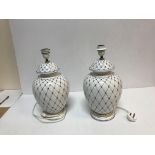 A pair of Italian pottery blue and white lattice decorated vase table lamps by A.