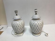 A pair of Italian pottery blue and white lattice decorated vase table lamps by A.