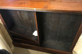 A Victorian mahogany open bookcase of two banks of adjustable shelving on a plinth base,