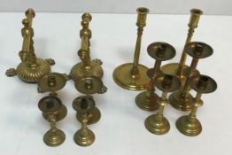 Five pairs of brass candlesticks,