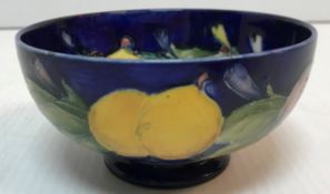 A Moorcroft yellow, purple and blue plum decorated pedestal bowl 13 cm diameter x 6.
