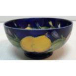 A Moorcroft yellow, purple and blue plum decorated pedestal bowl 13 cm diameter x 6.