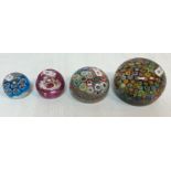 A collection of four millefiori paperweights various sizes,