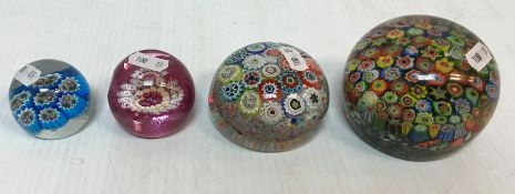 A collection of four millefiori paperweights various sizes,