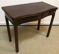 An Edwardian mahogany serpentine fronted fold-over card table in the George III taste,