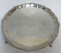 A silver salver with dragooned edge bearing inscription "Presented to Miss Esson by the members of