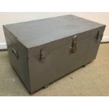 A silver painted tin trunk with central lock and double hasp and staple flanked by carrying handles,