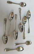 A collection of nine various Georgian silver table and dessert spoons to include a cut bright