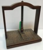 A 19th Century walnut and oak table top book press of typical form 43 cm x 31 cm x 48 cm high