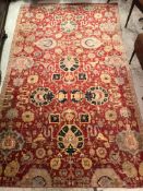 A Ziegler carpet with all-over foliate decoration on a red ground and cream and red stylised