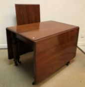 A Victorian mahogany rounded rectangular drop leaf extending dining table,