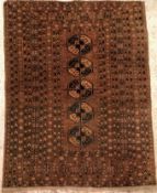 An Afghan rug, the central panel set with single row of repeating medallions on a brown ground,