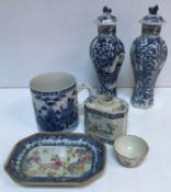 A similar pair of 19th Century Chinese blue and white hexagonal baluster vases and covers decorated
