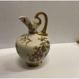 A Royal Worcester blushware pear shaped ewer with floral spray decoration raised on a circular foot