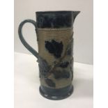 A Victorian glazed stoneware jug with holly decoration,