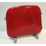 A mid 20th Century Falks Caprice heater in red bearing label together with a matching cream version