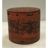 A Burmese red lacquered cylindrical betel box with script to front 21 cm diameter x 19.