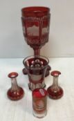 A 19th Century ruby overlaid cut glass oversized goblet decorated with town scene panels including