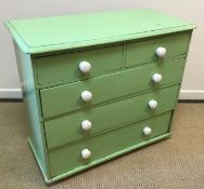 A white painted pine chest of two short over two long drawers with turned knob handles,