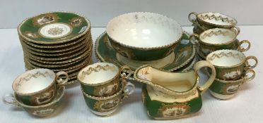 A 19th Century tea set with green and gilt decoration and hand-painted scenes depicting landscapes