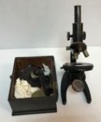 A Carl Zeiss microscope No'd 297187 1944 to front together with a box of assorted lenses etc