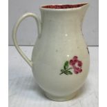 An 18th Century Liverpool type baluster shaped sparrow beak cream jug with floral spray decoration,