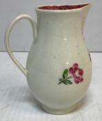 An 18th Century Liverpool type baluster shaped sparrow beak cream jug with floral spray decoration,