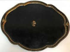 A Victorian painted and gilded tin shaped oval tray with central dog's head motif bearing Victorian