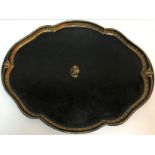 A Victorian painted and gilded tin shaped oval tray with central dog's head motif bearing Victorian