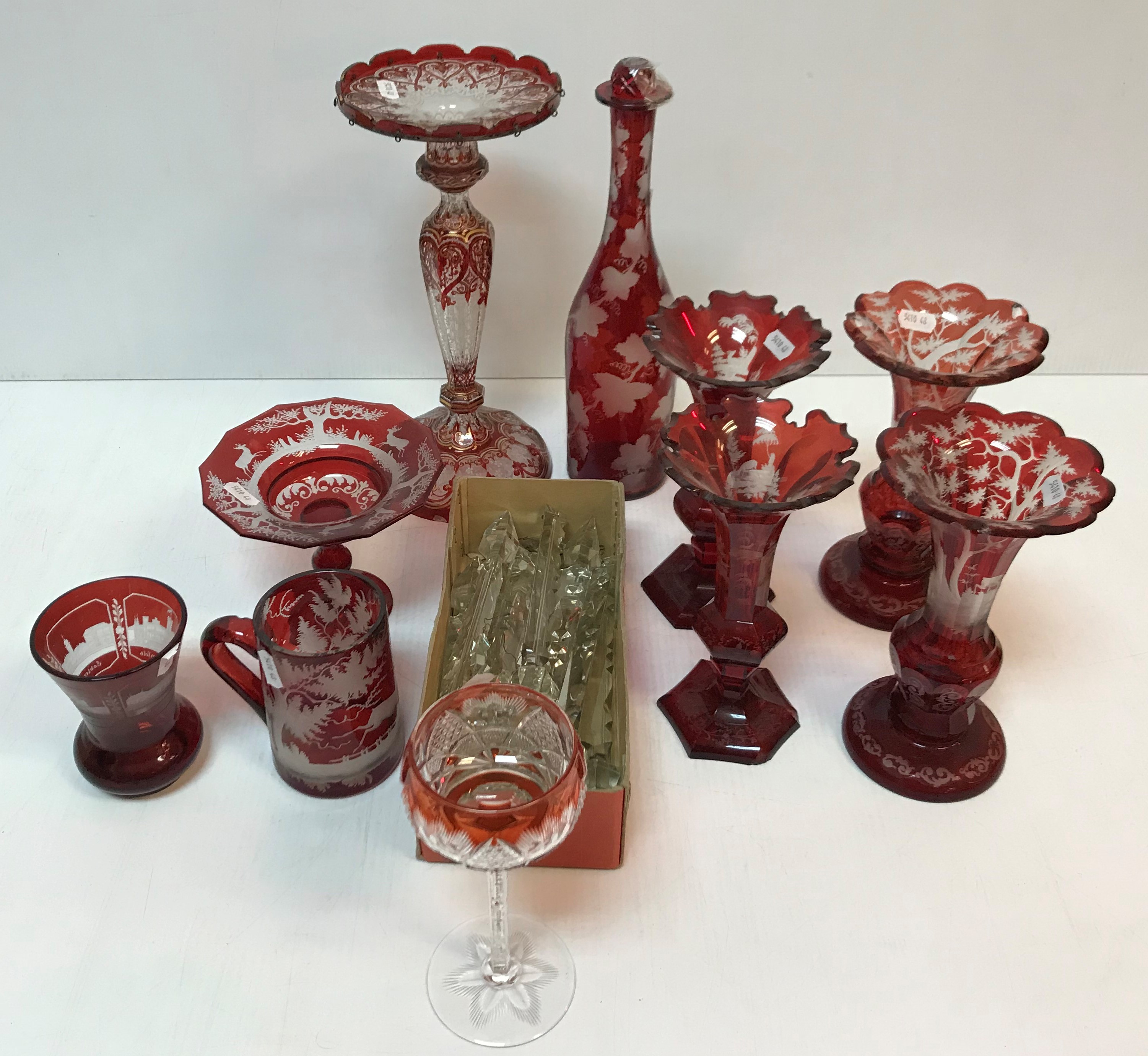 A collection of ruby glass overlaid vases, table lustre, bottle, mug, squat vase and tazza (10),