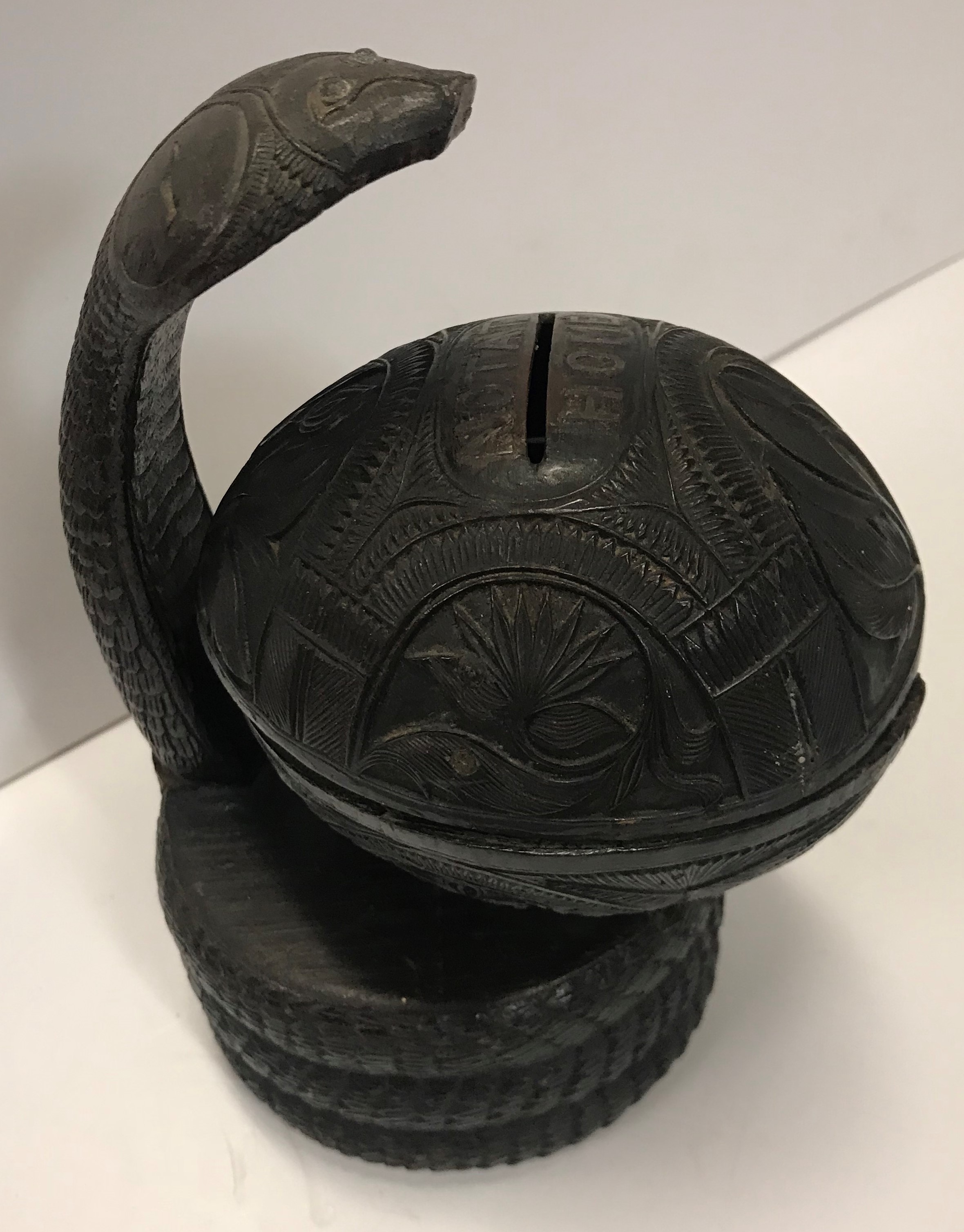 A 19th Century money box in the form of a coconut with incised leaf decoration and inscribed "Notat