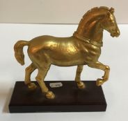 A 19th Century ormolu figure of a Spanish horse on a mahogany base unnamed,