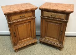 A pair of Continental satin walnut and inlaid pot cupboards with marble tops over a single drawer