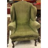 An 18th Century upholstered wing back scroll arm chair on cabriole front legs to pad feet,