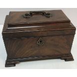 A George III mahogany tea caddy with brass handle,