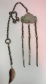 A Chinese Qing Dynasty jade and white metal chatelaine with agate leaf pendant and central green