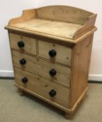 A late Victorian pine dressing chest with three quarter galleried top over two short and two long