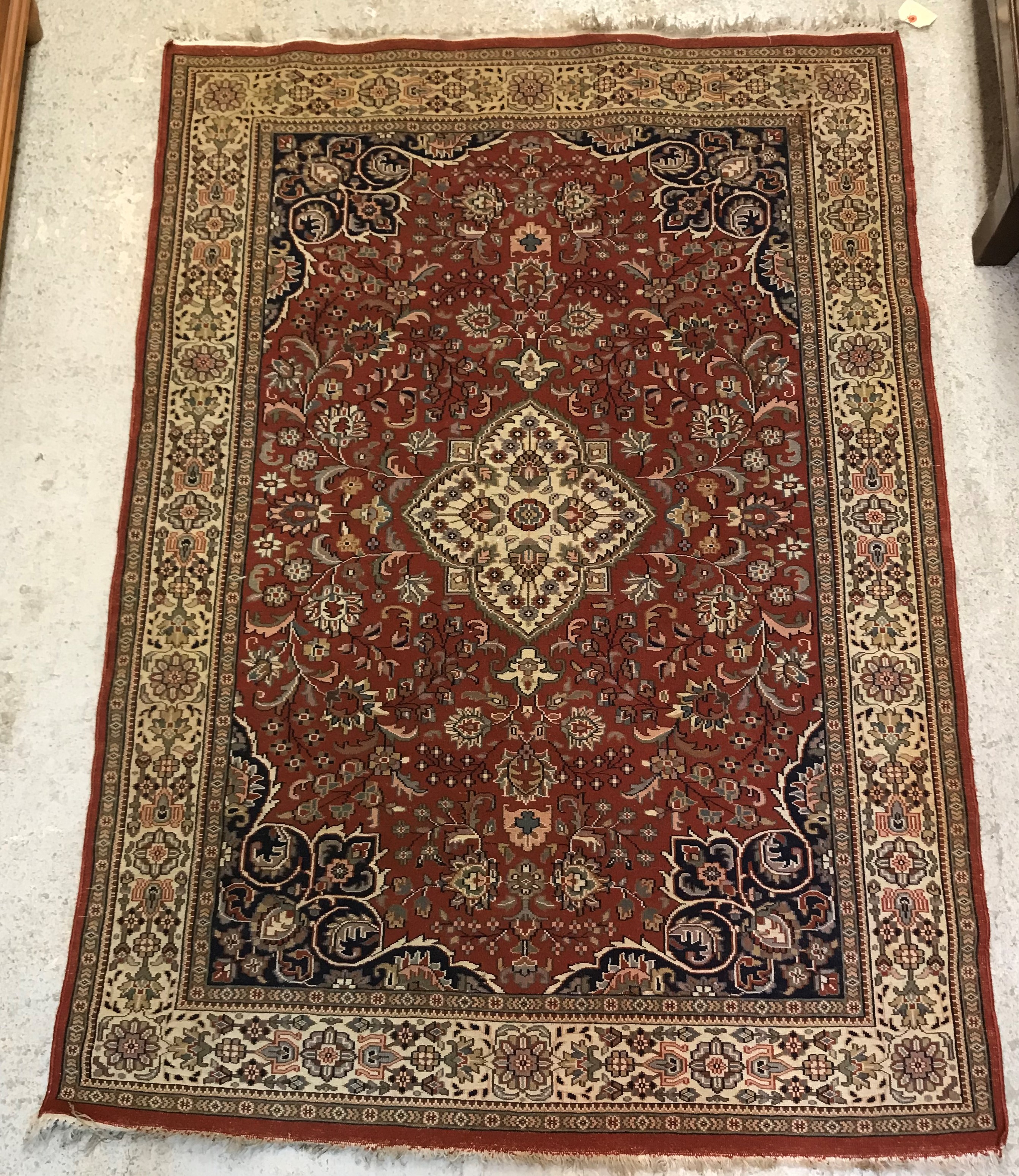 A Persian rug, the central panel set with floral decorated medallion on a brown ground, - Image 2 of 2