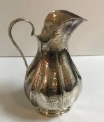 A modern silver pitcher of petal form stamped with Bruce Russell of Guernsey's marks dated 2005 19