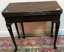 A George III style mahogany triple fold-over card / tea table with plain and baize-lined surfaces