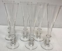 A set of six 20th Century champagne or ale flutes in the Georgian style with facet cut bowls on a