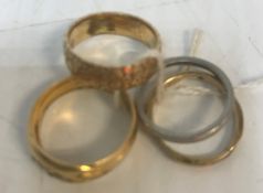 A collection of four rings comprising a 22 carat gold and stone set ring, 4 g,