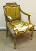 A 19th Century carved giltwood and gesso framed elbow chair in the Regence style with upholstered