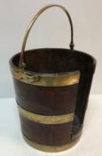 A Georgian mahogany and brass bound plate bucket with swing handle 39.